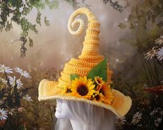 a yellow crocheted hat with sunflowers on it