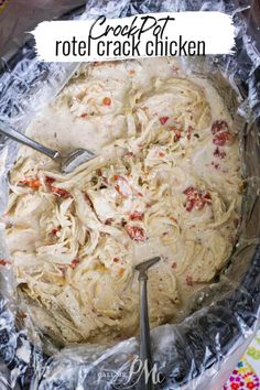 a pan filled with pasta and sauce on top of aluminum foil covered in plastic wrap