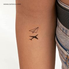 a woman's arm with an airplane tattoo on the left side of her arm