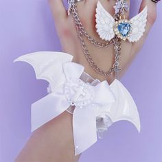 Introducing the Jirai Kei cross devil wings lace bowknot wrist cuff in white/white and blue! This stylish wrist cuff features a unique combination of devil wings and bowknot design, making it a perfect accessory for those who love Jirai Kei and Kawaii fashion. The white and blue color scheme adds a touch of elegance and playfulness to any outfit.  Please note that this product includes only the wrist cuff. Blonde Hair Korean, Fantasy Jewelry Magic, Devil Wings, Hair Korean, Coquette Clothes, Vtuber Design, Jewelry Magic, Cosplay Inspiration, Steampunk Fashion Male