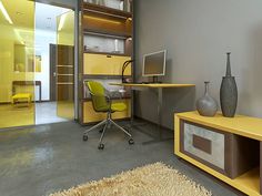 a room with a desk, chair and yellow cabinet in it's center area