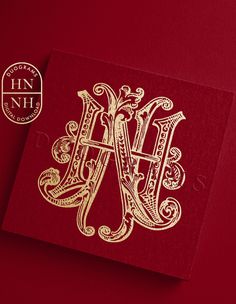 a red and gold monogrammed card with the initials h and m on it