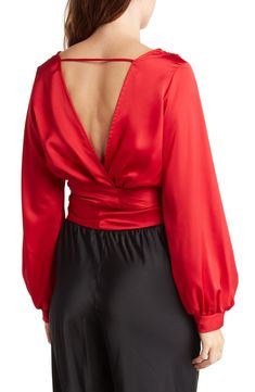 A surplice V-neck and long sleeves frame this solid colorway top crafted from silky-smooth satin fabric. 23" length (size S) Surplice V-neck Long sleeves 97% polyester, 3% spandex Hand wash, line dry Made in the USA of imported fabric Model stats: 5'10" height, 32" bust, 25" waist, 36" hip. Model is wearing size S. Evening Long Sleeve Top With Satin Finish, Silk V-neck Top For Night Out, Elegant Long Sleeve V-neck Top For Night Out, Chic Surplice Neckline Tops For Evening, Long Sleeve V-neck Top For Fall Party, Spring Evening Wrap Top With Long Sleeves, Sleek V-neck Party Tops, Long Sleeve Satin Finish Tops For Spring, Long Sleeve Tops With Satin Finish For Spring