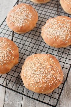 sesame seed buns on a cooling rack ready to be baked in the oven for lunch