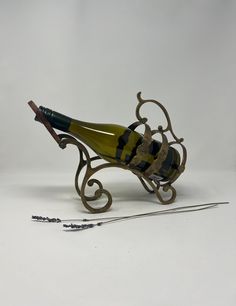 a wine bottle holder sitting on top of a table next to a pair of scissors