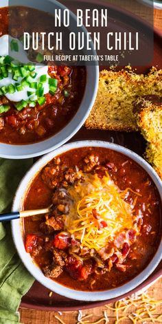 two bowls of chili with bread on the side