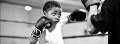 a young boy is practicing his boxing skills