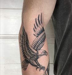 an eagle tattoo is shown on the arm