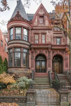 an old victorian style house in the fall