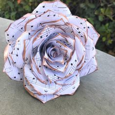 an origami rose with musical notes on it