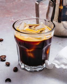 an iced drink with ice and coffee beans