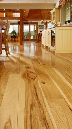 a wooden floor in a kitchen and dining room