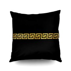 a black pillow with gold greek border