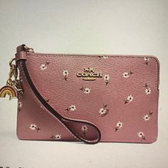 Coach Ditsy Daisy Print And Charms -Printed Coated Canvas -Two Credit Card Slots -Zip Top Closure -Fabric Lining -Wrist Strap Attached 6 1/4” (L)X4”(H) Packaged In A Coach Gift Box Trendy Pink Wristlet For Spring, Spring Coach Wristlet For Everyday Use, Coach Spring Wristlet For Everyday, Coach Wallets As Spring Gifts, Coach Wristlet For Daily Use, Pink Wristlet For Everyday Use In Spring, Pink Spring Wristlet, Pink Pouch Wristlet For Spring, Spring Pink Pouch Wristlet