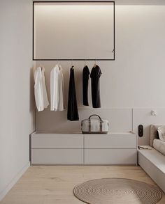 a white room with clothes hanging on the wall