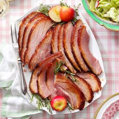 sliced ham on a plate with apples and salad