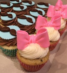 cupcakes decorated with pink bows and chocolate cookies