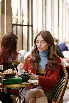 a woman sitting at a table eating food