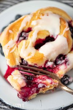 blueberry pie on a white plate with a fork