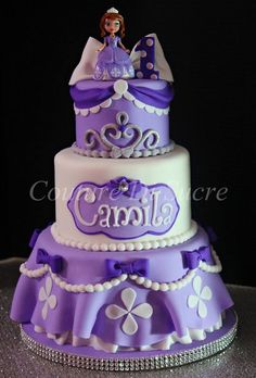 a purple and white cake with princess on top