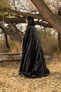 This full length Black Adult Cloak is perfect for a variety of dress up occasions; wear to any Halloween Party, Cosplay, Role Playing, Gothic, Steampunk, Renaissance, Medieval Events or a Masquerade Ball! Made from crushed black velvet, measuring from 60.5" from neckline to hem Fully lined hood and ornate metal fastening clasp Machine washable and made for repeat use Breathable, Silky Soft, 100% Polyester Fabrics Dress Ups & Accessories Sold Separately Cloak With Fur, Velvet Cloak, Hood Cape, Cosplay Costumes For Men, Cape With Hood, Black Cloak, Cape Cloak, Palm Coast, Masquerade Ball