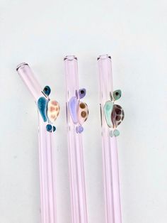 three glass pens with sea animals on them