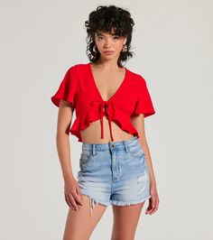 Sweeten your every day in this adorable flutter sleeve crop top on any casual occasion! Featuring playful flutter short sleeves, a trendy tie front design, and a cute ruffled crop hem, this top is perfect for adding a touch of fun to any outfit. Complete the look in jeans and block heels.Fit & FeaturesWoven fabric, no stretchFlutter short sleevesTie front designRuffled crop hemRuns true to size Flirty Short Sleeve Crop Top For Summer, Flirty Short Sleeve Summer Crop Top, Short Sleeve Ruffled Crop Top For Day Out, Trendy Ruffled Short Sleeve Crop Top, Summer Crop Top With Short Sleeves For Day Out, Chic Short Sleeve Crop Top With Ruffles, Trendy Short Sleeve Ruffled Crop Top, Trendy Short Sleeve Crop Top With Ruffles, Red Short Sleeve Crop Top For Summer