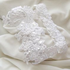 "Beautiful and lovely garter set made of white pearl beaded alencon lace. Hand sews 1\" white stretch lace. Soft and warm. Comfortable fitting garter set. Please choose your thigh size. Your garter will ship in a lovelike gift box. If you have any questions please feel free to contact me. Thanks :) ● How to measure garter size Wrap one end of the flexible measuring tape around your upper thigh. The garter is generally worn 3 to 4 inches above the knee. Please choose your natural(true) size. I re Fitted Lace Bridal Belt For Bride, Fitted White Lace For Wedding Night, White Bridal Belt For Bride, Fitted Lace Trim Bridal Accessories For Bride, Fitted White Lace For Bride, Fitted White Bridal Lace, White Fitted Lace For Bride, Elegant Stretch Lace For Wedding, Fitted White Lace Bridal Belt