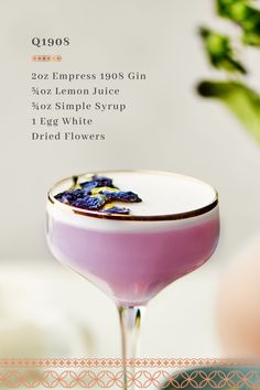 a pink cocktail with lemon juice and blueberries on the rim