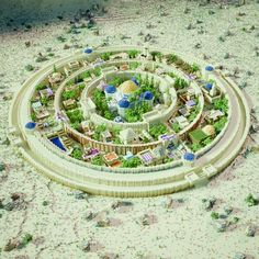 an aerial view of a building surrounded by trees and bushes in the middle of a desert