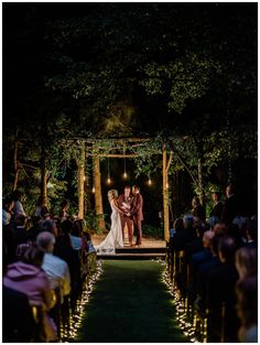 a bride and groom standing at the end of their wedding ceremony in front of an audience