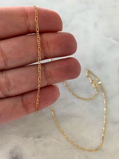 "14K Gold Figaro Chain, Dainty Necklace, Yellow Gold, 1.3mm Wide, Real Gold, Hollow, Figaro Link Chain, Figaro Curb Chain, Stacking, Layering This beautiful Solid 14k Yellow Gold necklace can be worn as a choker, as a layering piece or stacking piece. It will add statement to your outfit. It can be combined with multiple chains of different lengths to give the messy chains look. It comes available in 14k Yellow Gold. This is real gold. ♦ Materials: 14k Gold ♦ Available colors: Gold ♦ Necklace me Dainty Yellow Gold Jewelry With Figaro Chain, Gold Figaro Chain Necklace For Wedding, Dainty Figaro Chain For Jewelry Making, 14k Gold Dainty Chain Necklace With Diamond Cut, Dainty 14k Gold Chain Necklace With Diamond Cut, Figaro Link Chain Necklace For Anniversary, Dainty Figaro Chain Jewelry For Wedding, Dainty Yellow Gold Diamond-cut Chain Necklace, Dainty Yellow Gold Diamond Cut Chain Necklace