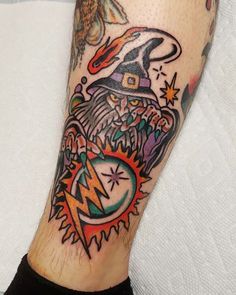 a man with a wizard hat and lightning bolt tattoo on his leg