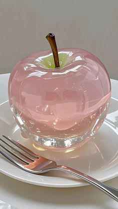 an apple on a plate with a fork