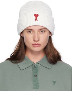 Rib knit virgin merino wool beanie in off-white. Embroidered logo patch at rolled brim. Supplier color: Off-white/Red Classic White Hat With Logo Patch, White Cotton Beanie For Winter, White Winter Hat With Embroidered Logo, Classic White Winter Beanie, Classic White Beanie For Winter, White Wool Casual Hat, White Wool Cap, Ami Paris, Wool Beanie