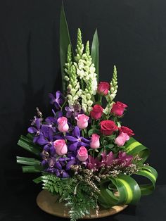 a vase filled with lots of different colored flowers