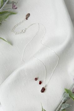 Spread joy and celebrate special moments with this exquisite birthstone set, a wonderful gift for those born in January. Featuring stunning natural garnet set in sterling silver. Sterling Silver (nickel and lead-safe) Garnet Necklace: 16-20.5", adjustable with sterling silver lobster claw clasp Earrings: sterling silver post and butterfly closure We hand select our natural materials, thus there may be slight variations in color and/or size that will not detract from the overall aesthetic Our uni Floyd Va, Clasp Earrings, Silver Gold Earrings, Born In January, Silver Gold Necklace, Simple Collage, Garnet Pendant, Garnet Necklace, Necklace And Earrings Set