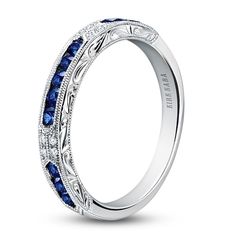 a wedding band with blue sapphire stones in the center and white diamonds on the sides