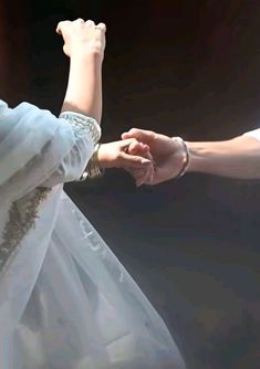 the bride and groom are holding hands