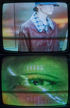 two televisions with an image of a person wearing a hat on top of them