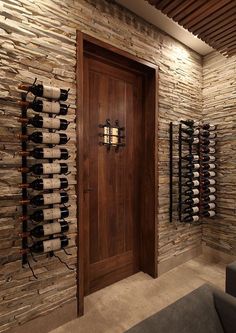 a wine cellar with many bottles of wine on the wall