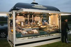 a man standing in front of a food cart at an outdoor event with the words fresh coffee from bread to cup written on it