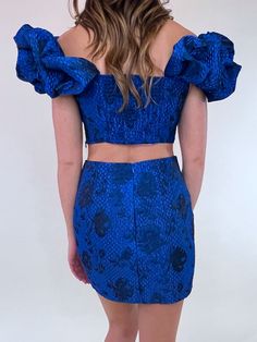 This metallic shimmer, blue floral mini skirt makes such a classy statement. Can pair with a black button up blouse with tights for an office holiday party look OR wear with the matching Blue But New Floral Puff Sleeve Corset﻿. Fitted Mini Skirt For Spring Party, Flirty Fitted Mini Skirt For Party Season, Elegant Ruffled Mini Skirt For Party, Holiday Fitted Skirt For Night Out, Fitted Mini Skirt For Date Night And Party Season, Fitted Trendy Skirt For Evening, Trendy Fitted Evening Skirt, Trendy Fitted Skirt For Evening, Chic Ruffled Mini Skirt For Party