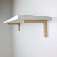 a white shelf with two holes in it