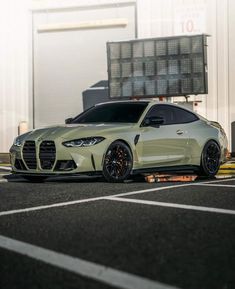 a white sports car parked in a parking lot