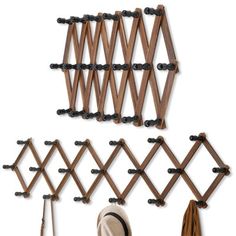 the coat rack is made out of wood and has several hooks on it, including two umbrellas