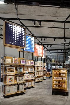 the interior of a store with many framed pictures