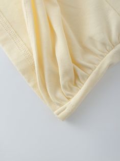 The Knot Tee-Vanilla is the perfect addition to any wardrobe. Crafted from lightweight materials, it is comfortable and easy to wear, yet durable and soft. Its subtle creamy vanilla color makes it both timeless and stylish. Beige Solid Color T-shirt For Summer, Cream Stretch Tops For Loungewear, Cream Summer Loungewear Tops, Cream Solid Color Top For Spring, Off White Cotton V-neck Top, Off White Spring Loungewear Top, Off White Cotton Loungewear Tops, Off White Cotton Tops For Loungewear, Cream Cotton Tops For Loungewear