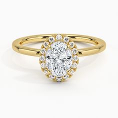 a yellow gold ring with an oval cut diamond surrounded by small round diamonds on the band