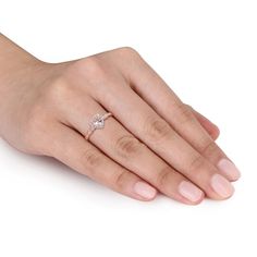 a woman's hand with a diamond ring on it